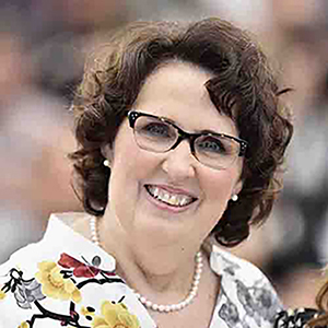 Phyllis Smith wearing a white blouse with colorful flowers attending a premier