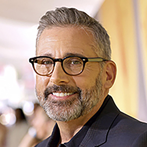 Steve Carell wearing a grey suit and glasses, attending a premier
